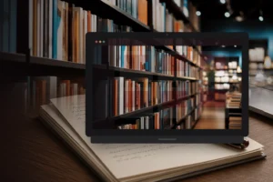 Laptop showing a bookstore shelf mock on a desk, library shelves softly blurred behind, no store badges.